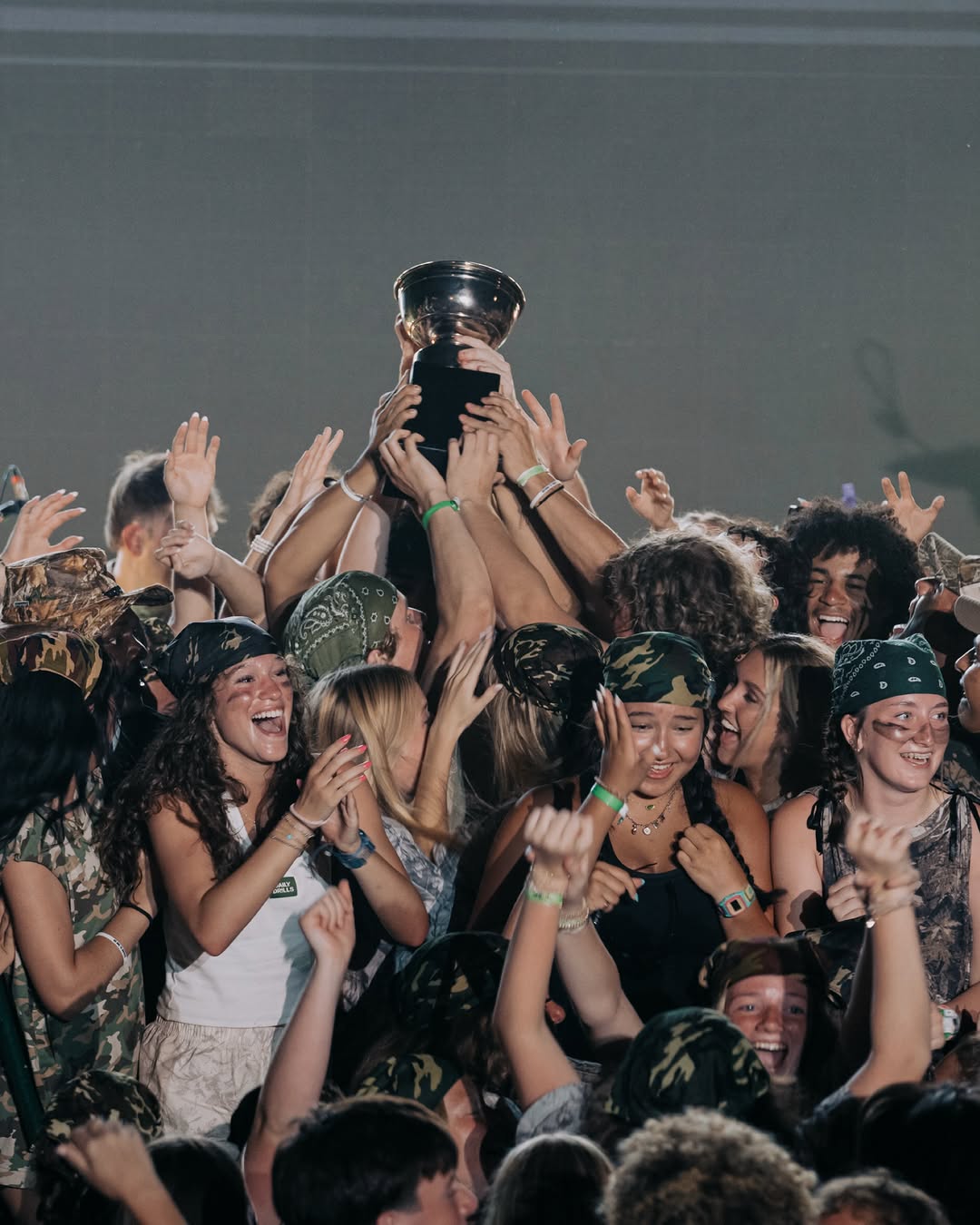 High school camp tribe winners celebrating with the trophy